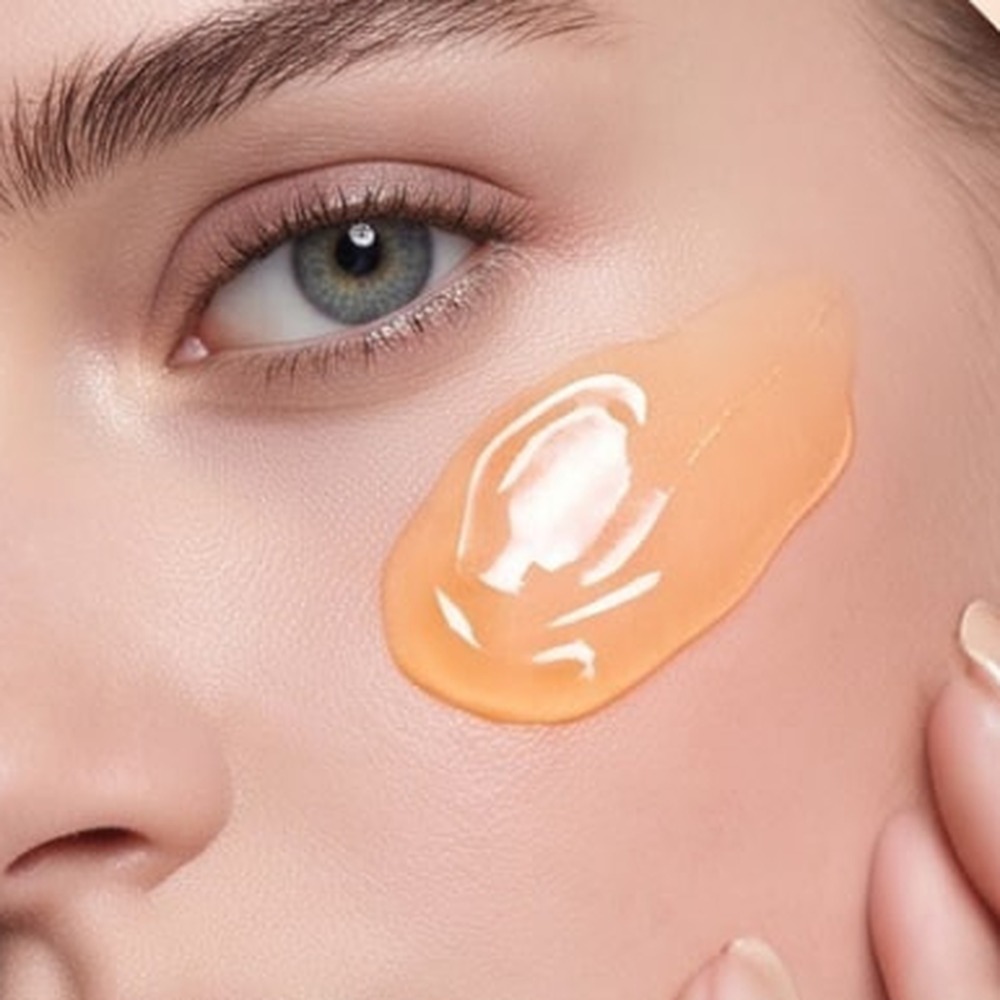 Applying orange enzyme gel to dry skin